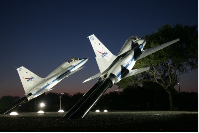 Night image of two, T-38 aircraft on display.