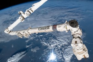 The Canadian Space Agency's major contribution to the International Space Station, the 57.7-foot-long Canadarm2 robotic arm, which can maneuver spacecraft, science payloads, and spacewalking astronauts, is pictured as the orbital lab soared 259 miles above a cloudy Texas.