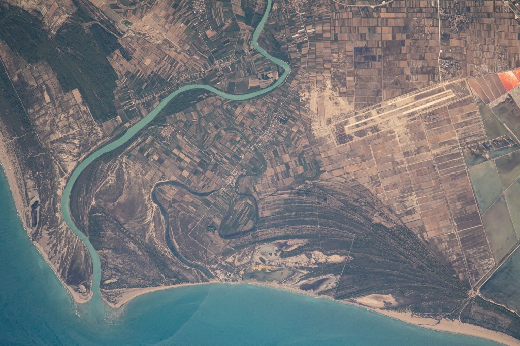 iss069e060397 (Aug. 15, 2023) --- The Aoos River in Albania leads to the Mediterranean Sea in this photograph from the International Space Station as it orbited 264 miles above southern Europe.
