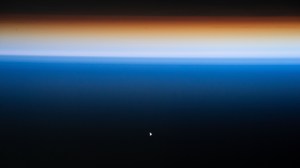 The SpaceX Dragon Endeavour crew ship (white dot at lower center) carrying four Axiom Mission 1 astronauts approaches the International Space Station during an orbital sunset less than a day after launching from NASA's Kennedy Space Center in Florida. Both spacecraft were orbiting 261 miles above the Philippine Sea near the U.S. island territory of Guam.