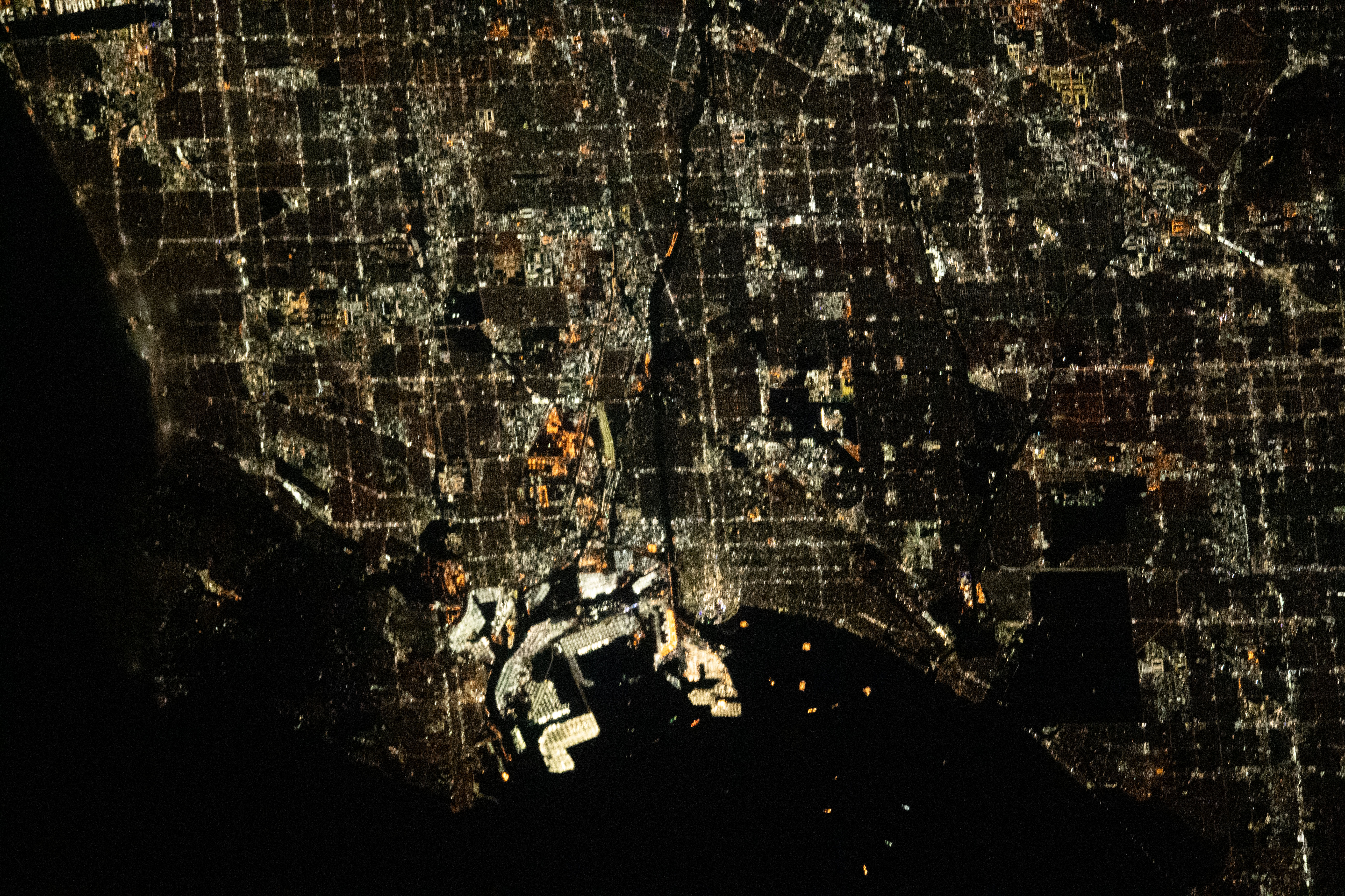 The city lights of Los Angeles, California, and its surrounding suburbs, are pictured from the International Space Station as it orbited 261 miles above. Terminal Island, an artificial island containing the ports of Los Angeles and Long Beach, is featured prominently at the bottom center of this photograph.