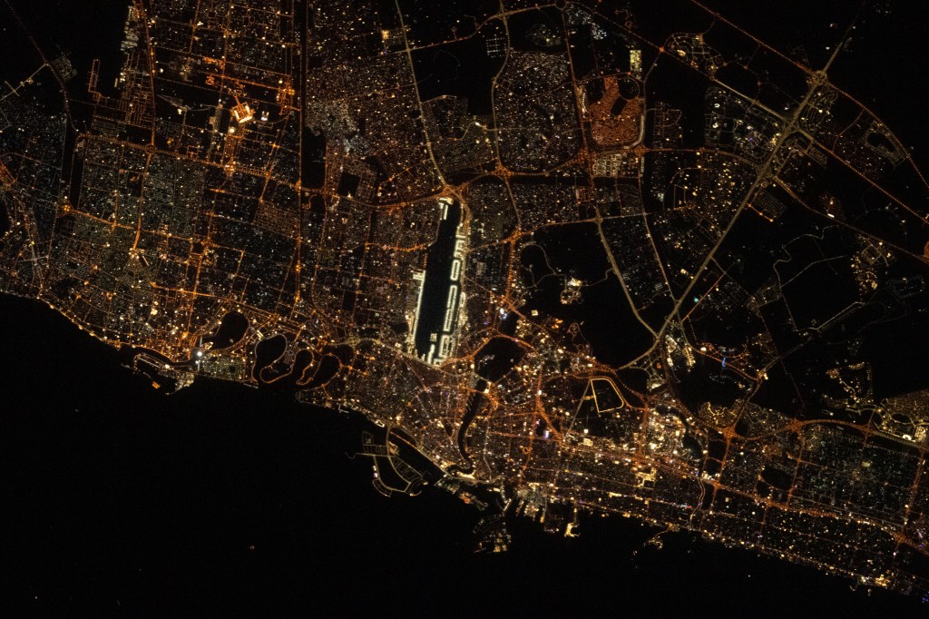 The city lights of Sharjah and Dubai in the United Arab Emirates, with Dubai International Airport (center) next to the Ras Al Khor Wildlife Sanctuary (dark area), are pictured from the International Space Station as it orbited 262 miles above.