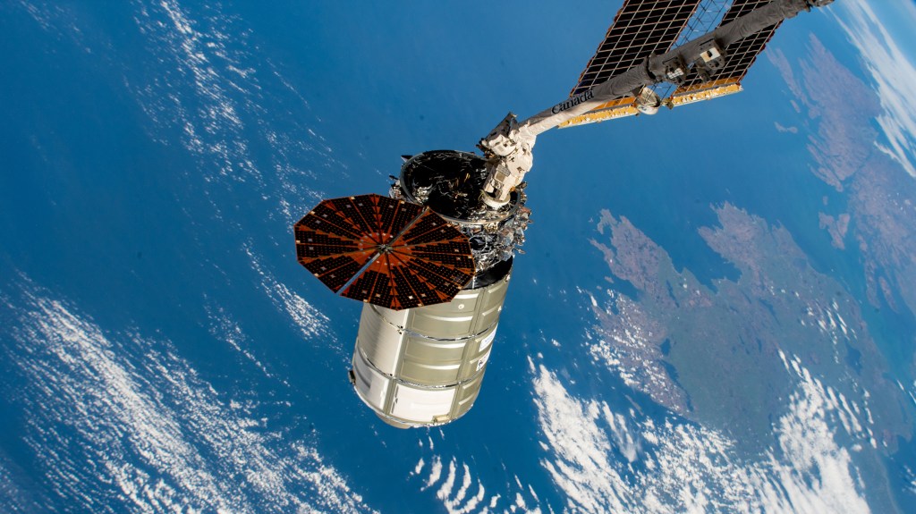 The Cygnus space freighter from Northrop Grumman is poised for release from the Canadarm2 robotic arm as the International Space Station orbited 263 miles above the Atlantic Ocean off the coast of Ireland.