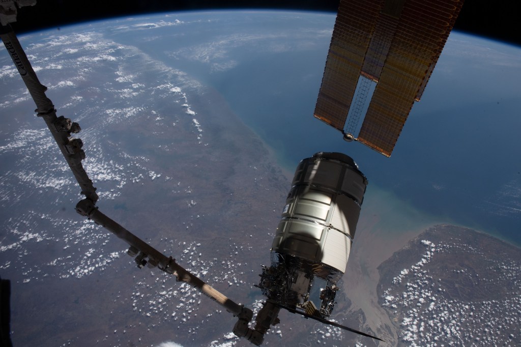The Cygnus space freighter from Northrop Grumman is pictured in the grips of the Canadarm2 robotic arm as the International Space Station orbited 258 miles above the Arabian Sea coast of India.
