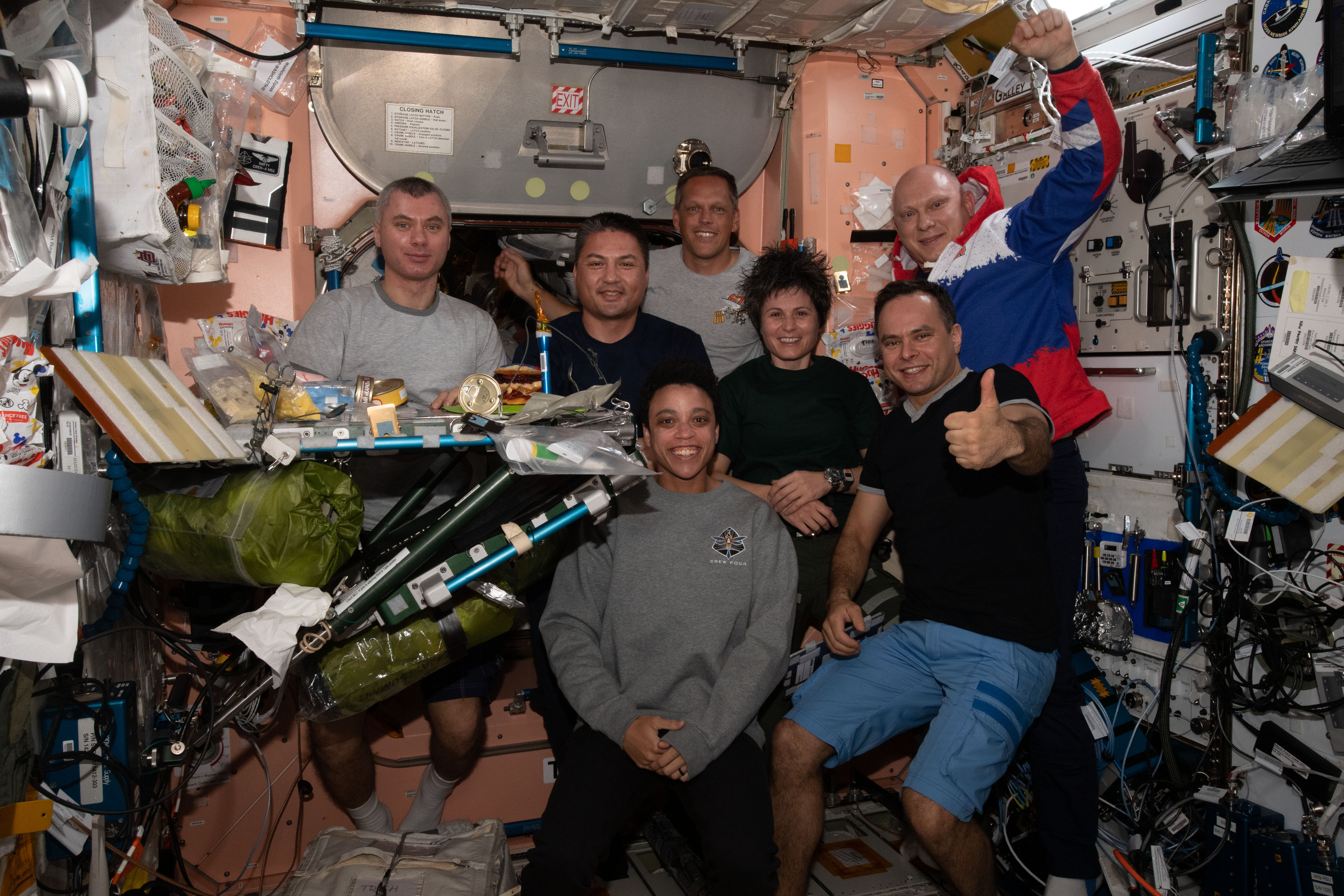 The Expedition 67 crew pose together for a portrait during dinner time inside the International Space Station's Unity module. In the front row (from left), are NASA Flight Engineer Jessica Watkins and Roscosmos Flight Engineer Sergey Korsakov. In the back (from left), are Roscosmos Flight Engineer Denis Matveev; NASA Flight Engineers Kjell Lindgren and Bob Hines; ESA (European Space Agency) Flight Engineer Samantha Cristoforetti; and Roscosmos Commander Oleg Artemyev.