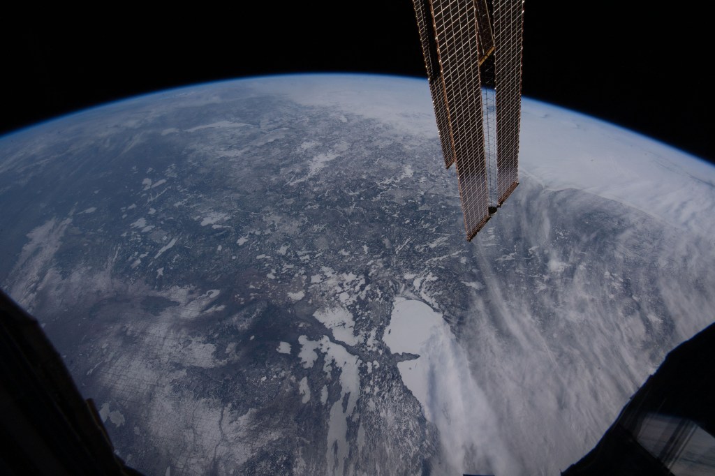 The icy, northern central portion of Canada is pictured from the International Space Station as it orbited 262 miles above. At bottom, are numerous frozen water bodies imcluding the largest one of Lake Winnipeg.