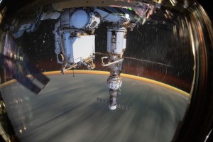 This long-duration photograph shows the Earth 259 miles below a soaring International Space Station. In the foreground, is the Soyuz MS-21 crew ship docked to the Prichal docking module which is itself attached to the Nauka multipurpose laboratory module.