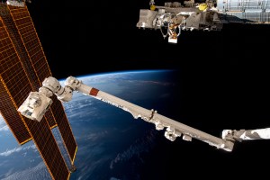 The International Space Station soars 266 miles above the coast of Argentina near the Rio de la Plata as it flies into an orbital sunset. In the foreground from left are, the station's main solar arrays, the Canadarm2 robotic arm, and the Kibo laboratory module's external research platform.