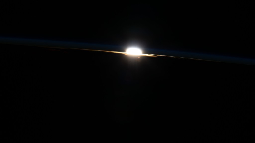 The last rays of an orbital sunset burst through Earth's horizon as the International Space Station flew 258 miles above Brazil.