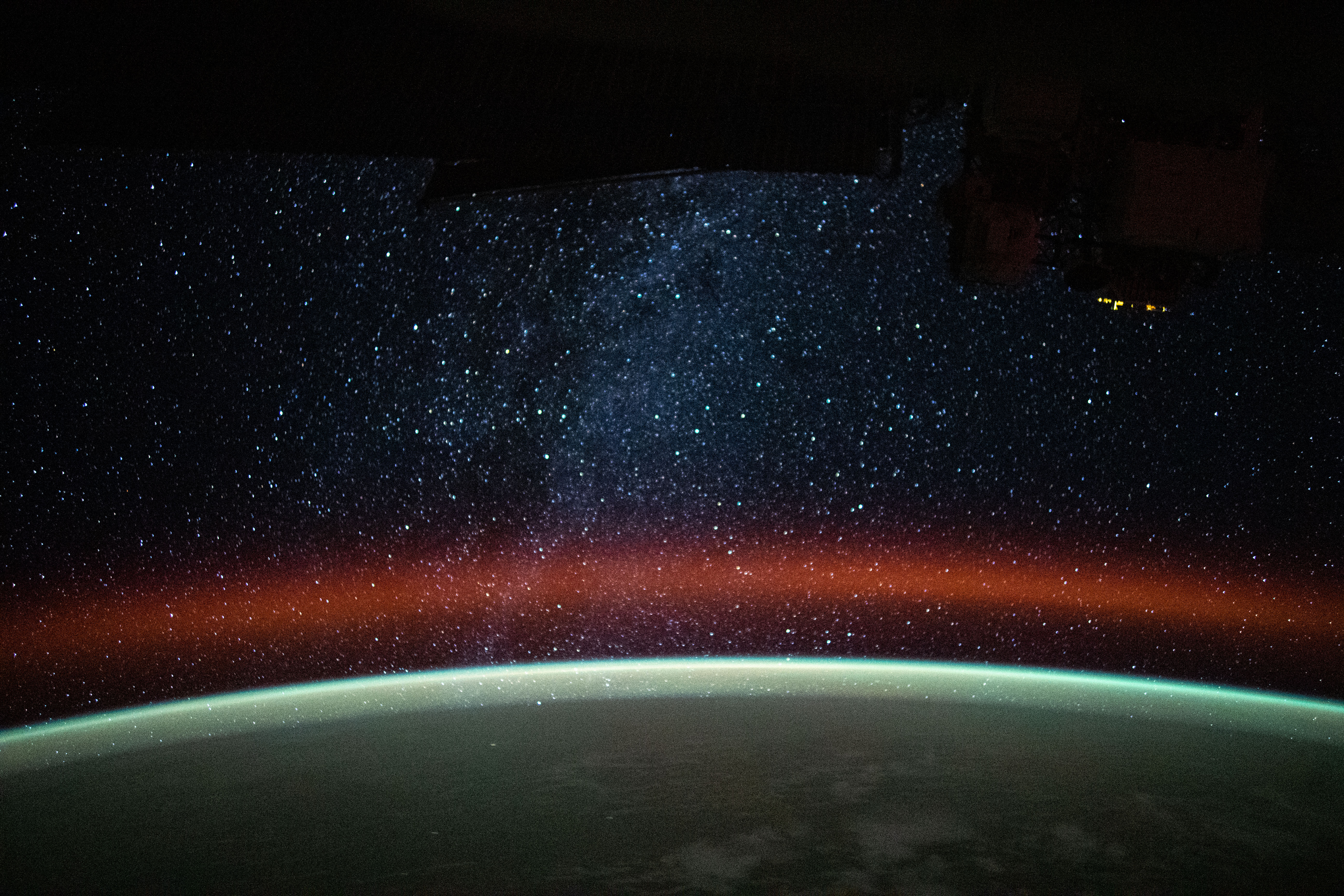 This long-duration photograph was taken from the International Space Station at an altitude of 259 miles above the island nation of Vanuatu northeast of Australia. The Milky Way is pictured above Earth's atmospheric glow blanketing the planet's horizon.