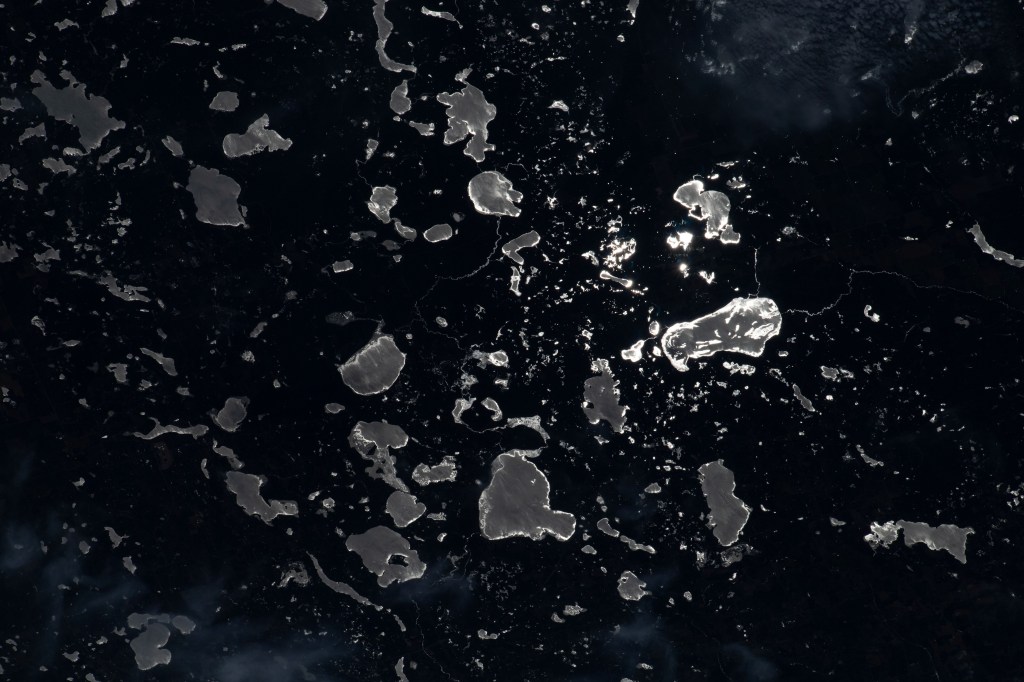The Moon's glint beams off lakes on the U.S.-Canadian border, between the state of Minnesota and the province of Ontario, in this nighttime photograph from the International Space Station as it orbited 260 miles above North America.