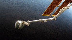 The Nanoracks Bishop Airlock is pictured in the grips of the Canadarm2 robotic arm as it is positioned away from the International Space Station. The commercial platform was being maneuvered prior to jettisoning a trash container for a fiery, but safe disposal above Earth's atmopshere. Bishop is a multi-faceted airlock attached to the Tranquility module used not only to discard trash, but also to host research payloads, deploy satellites, and serve as a testbed for a variety of space technologies.