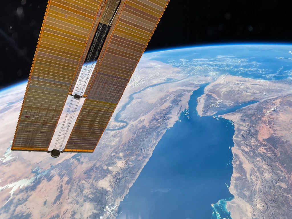 The Nile River and the Red Sea lead to the Mediterranean Sea and are pictured from the International Space Station as it orbited 258 miles above the Arabian Peninsula. A pair of the space station's main solar arrays drapes across the left foreground.