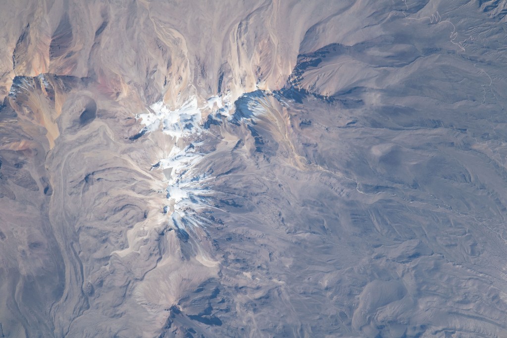 The snow-covered peak of the extinct Volcano Chachani is pictured from the International Space Station as it orbited 261 miles above the Peruvian Andes on the South American continent.