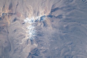 The snow-covered peak of the extinct Volcano Chachani is pictured from the International Space Station as it orbited 261 miles above the Peruvian Andes on the South American continent.