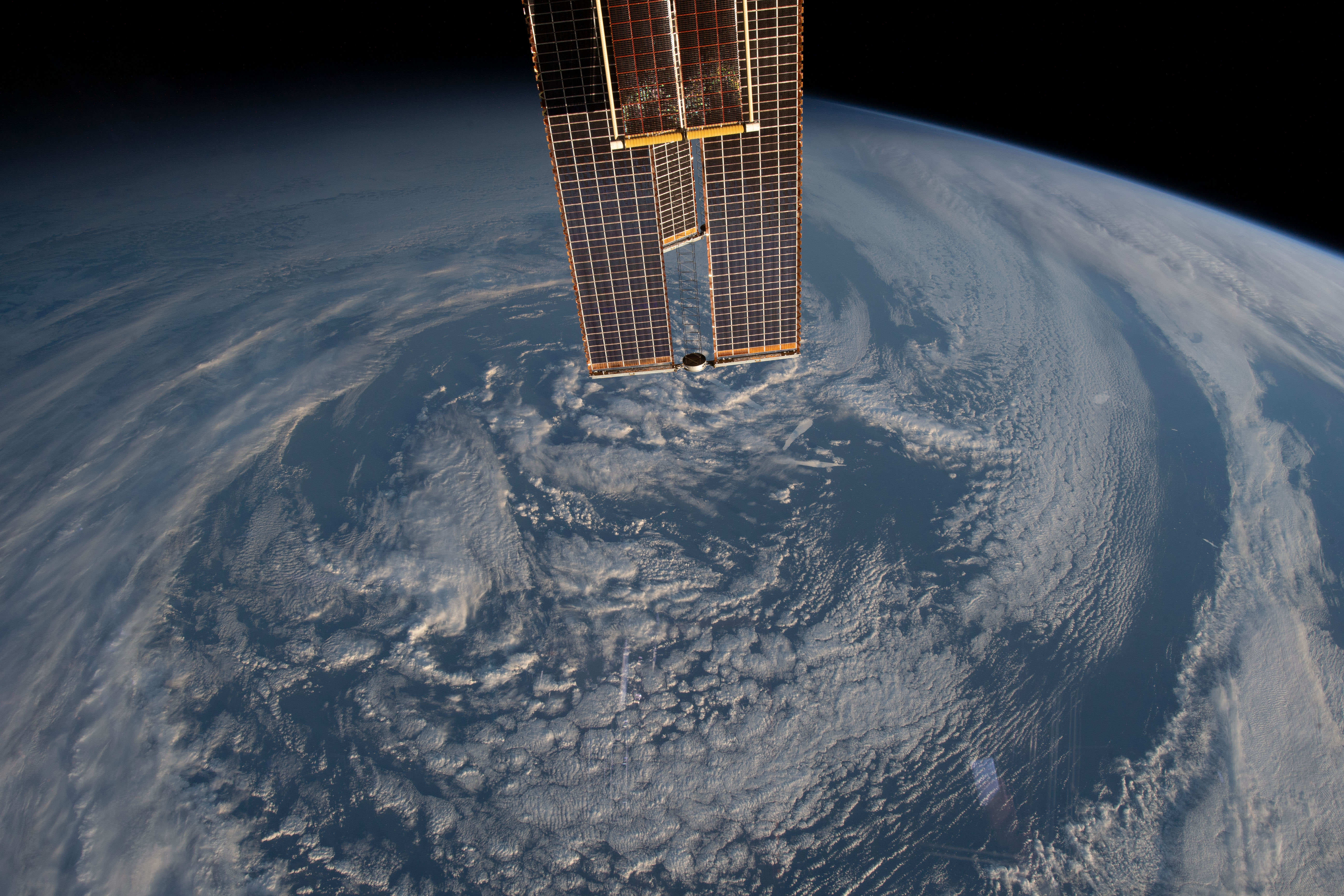 The International Space Station was orbiting 270 miles above the south Atlantic Ocean about 350 miles north of South Georgia Island when this photograph was taken. In the top foreground, portions of the station's main solar array and roll-out solar array are also pictured.