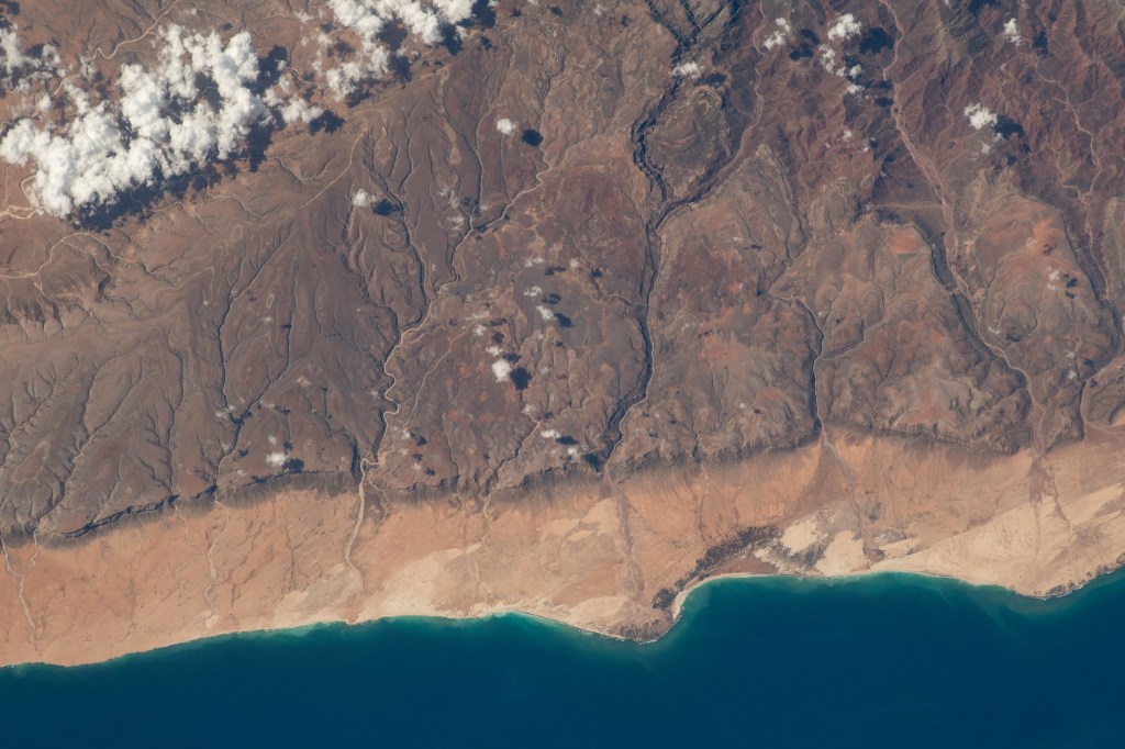 The southern coast of Yemeni's island of Socotra in the Arabian Sea was pictured by NASA astronaut and Expedition 69 Flight Engineer Woody Hoburg as the International Space Station orbited 257 miles above.