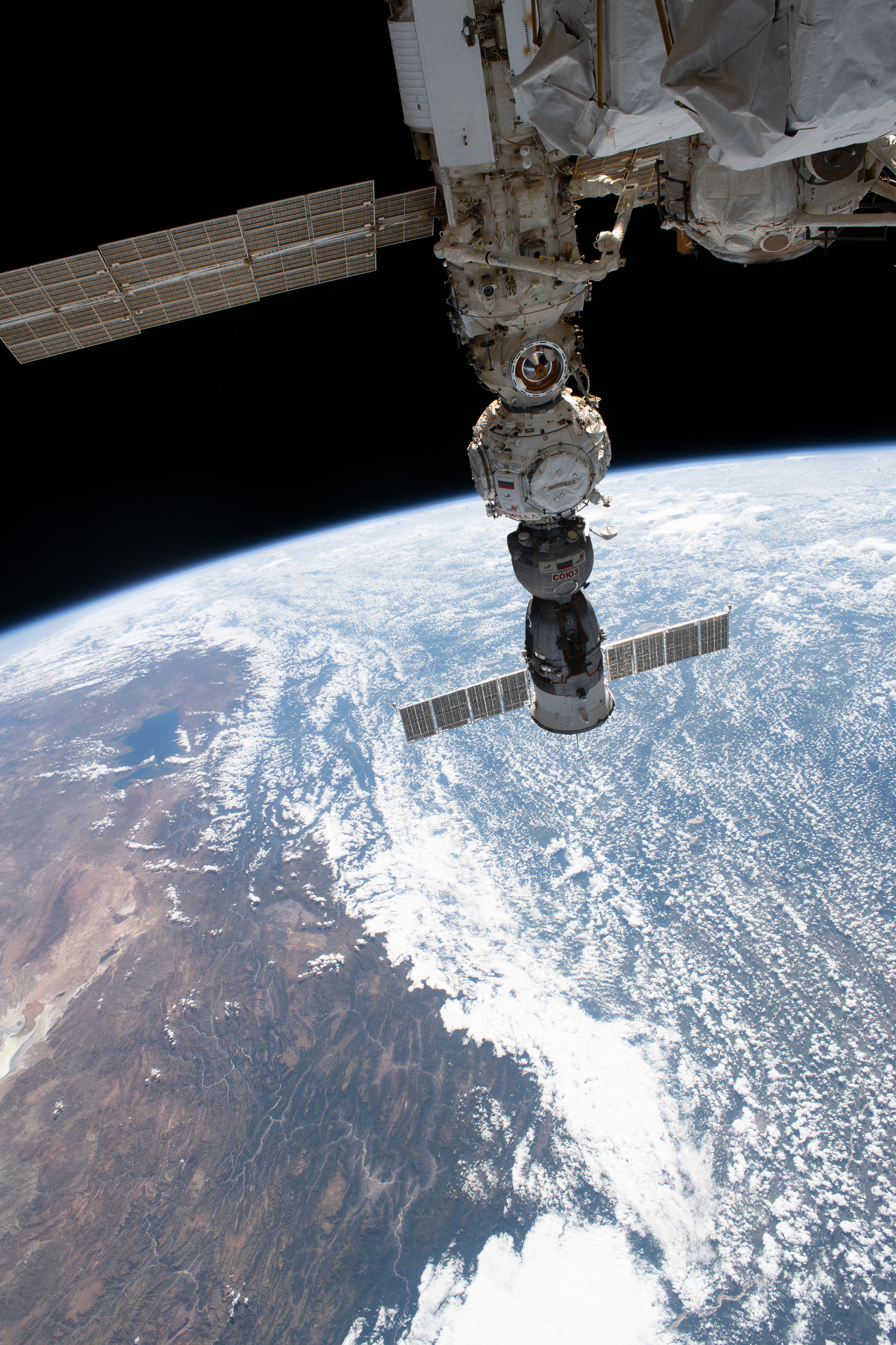 Four main components on the Roscosmos segment of the International Space Station are pictured as the orbital outpost soared 260 miles above the Andes mountain range in Bolivia. From top to bottom, are the Nauka multipurpose laboratory module, the European robotic arm attached to Nauka, the Prichal docking module, and the Soyuz MS-23 crew ship.