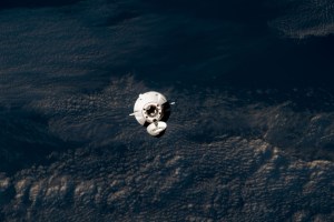 The SpaceX Dragon cargo craft approaches the International Space Station for an automated docking less than a day after launching from NASA's Kennedy Space Center loaded with over 7,000 pounds of science experiments, station hardware, and crew supplies. Both spacecraft were orbiting 259 miles above the Pacific Ocean off the coast of Japan at the time of this photograph from the orbital outpost.
