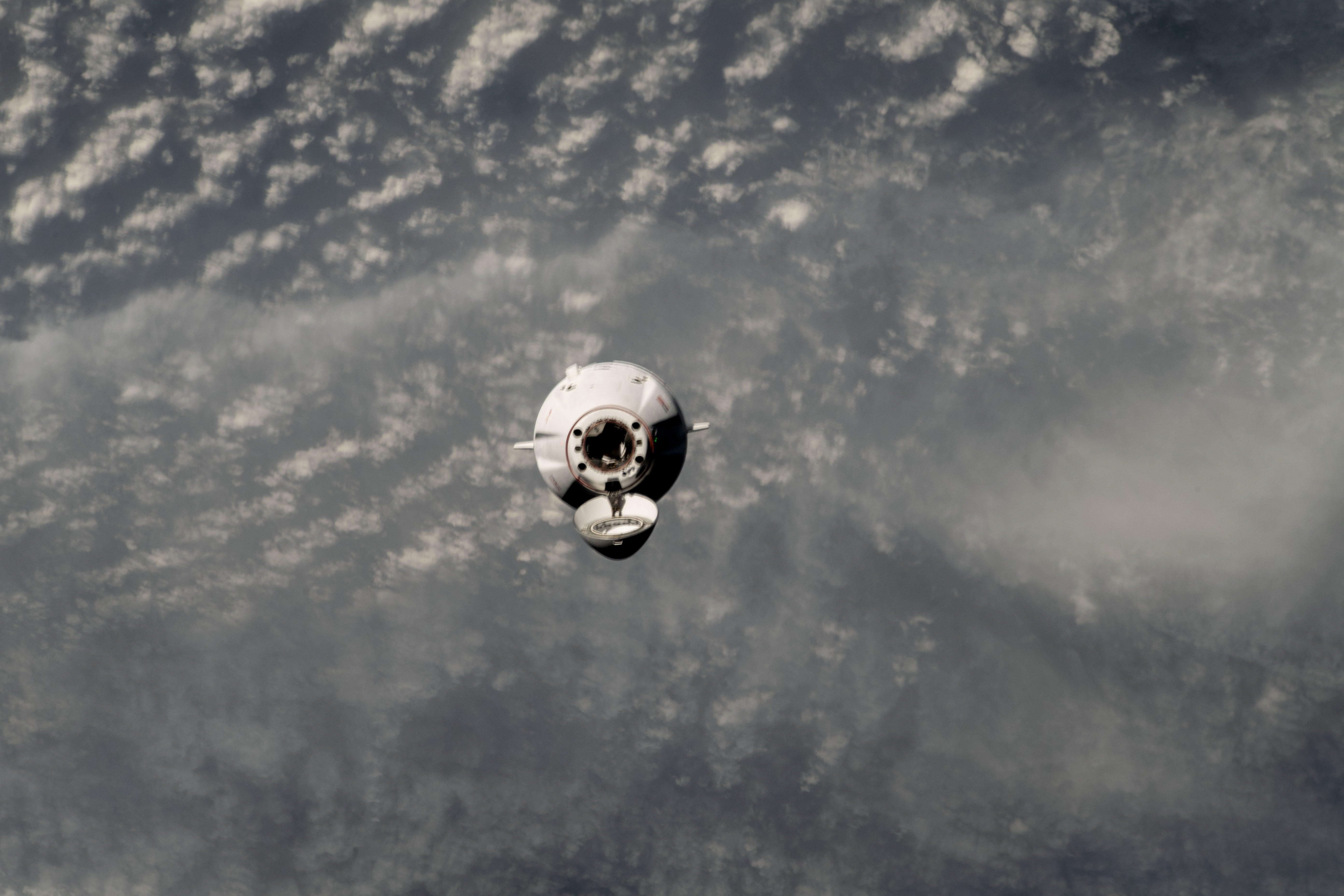 The SpaceX Dragon cargo craft approaches the International Space Station for an automated docking less than a day after launching from NASA's Kennedy Space Center loaded with over 7,000 pounds of science experiments, station hardware, and crew supplies. Both spacecraft were orbiting 259 miles above the Sea of Japan at the time of this photograph from the orbital outpost.
