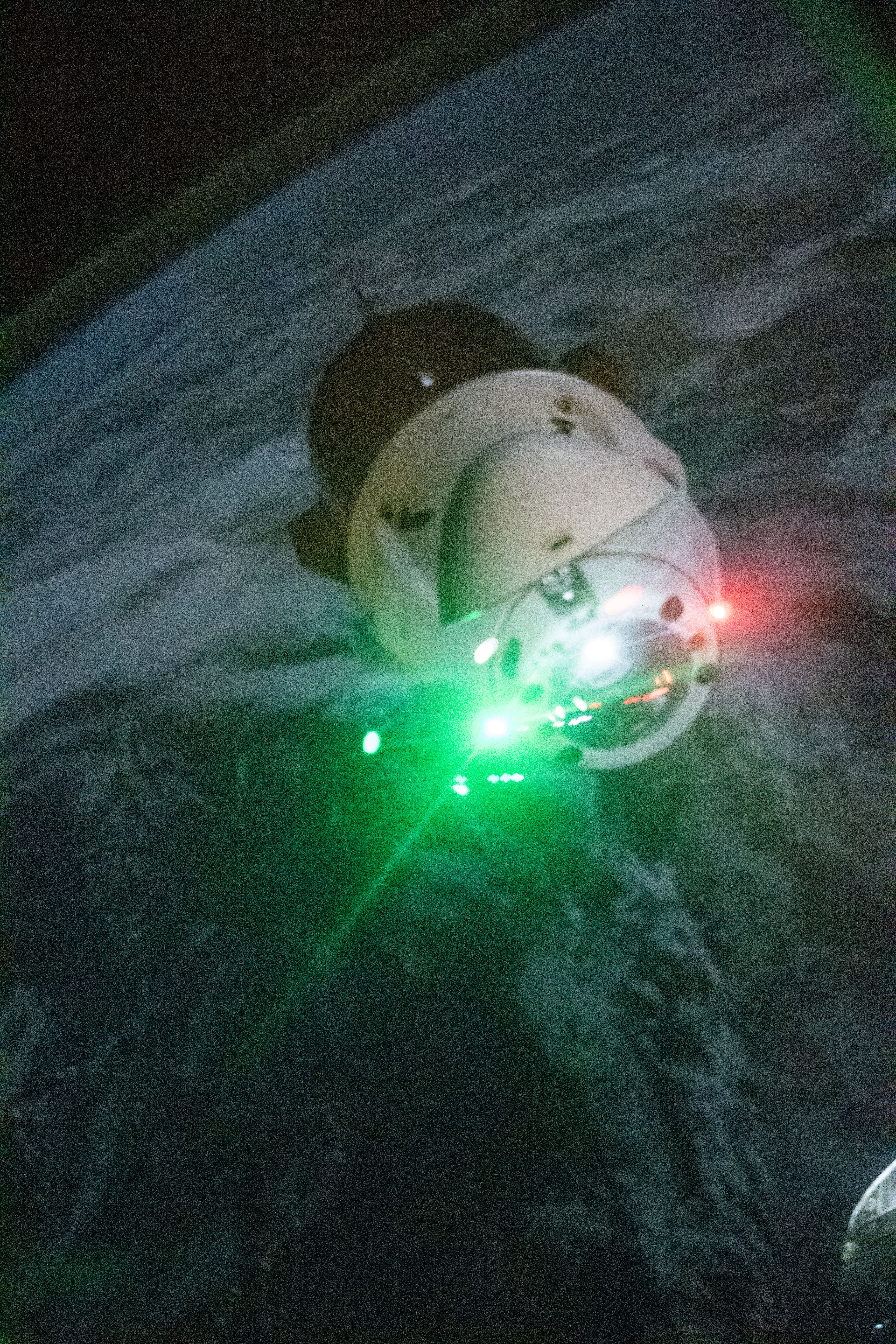 The SpaceX Dragon Endeavour spacecraft is pictured shortly after undocking from the Harmony module's space-facing port on the International Space Station during orbital night time. The red and green lights on Dragon are navigation lights with red signifying the port side of the spacecraft and green representing the starboard side.