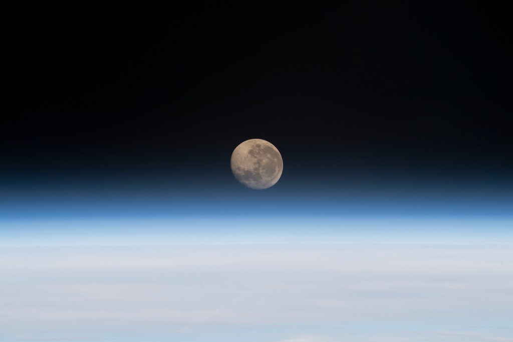 The waxing gibbous Moon is pictured above Earth's horizon in this photograph from the International Space Station as it orbited 261 miles above the Atlantic Ocean off the coast of Namibia.