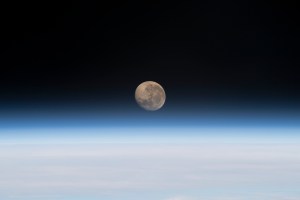 The waxing gibbous Moon is pictured above Earth's horizon in this photograph from the International Space Station as it orbited 261 miles above the Atlantic Ocean off the coast of Namibia.