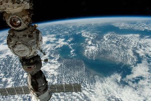 Three Roscosmos components on the International Space Station were photographed by UAE (United Arab Emirates) astronaut and Expedition 69 Flight Engineer Sultan Alneyadi while orbiting 263 miles above a partly cloudy northern Europe. At left, from top to bottom, are the Nauka multipurpose laboratory module's forward port, the Prichal docking module, and the Soyuz MS-23 crew ship.
