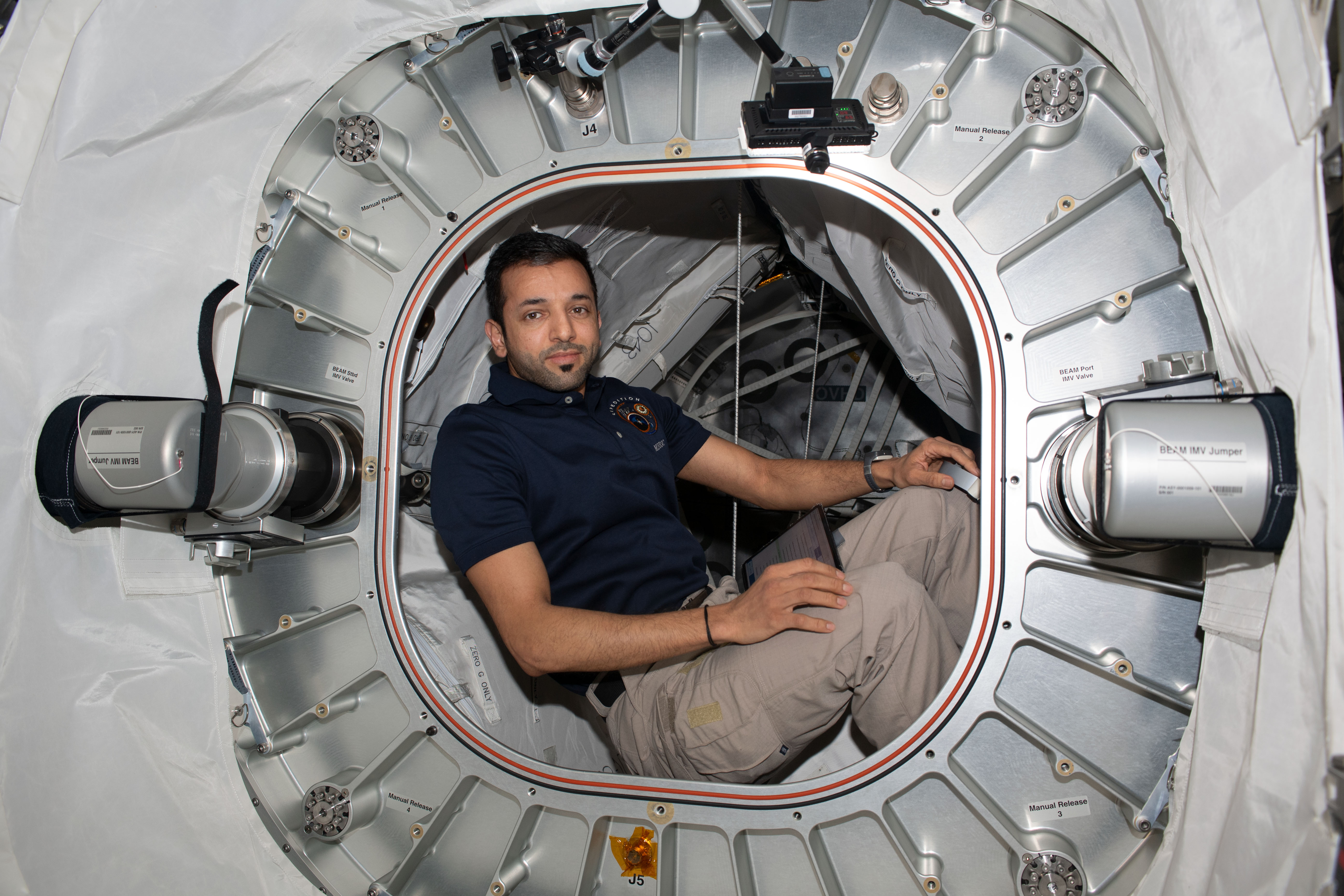 UAE (United Arab Emirates) astronaut and Expedition 69 Flight Engineer Sultan Alneyadi poses for a portrait inside the Bigelow Expandable Activity Module, or BEAM.