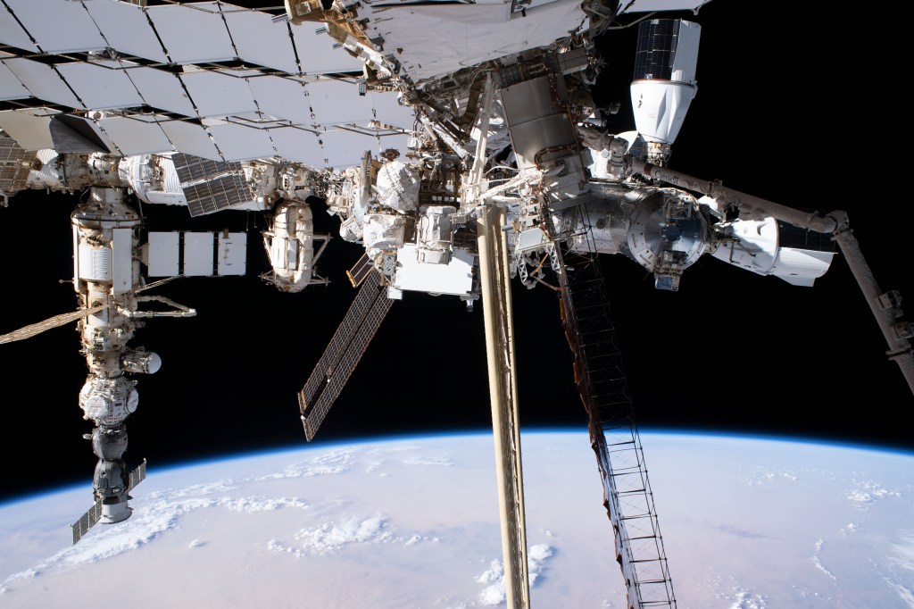 This view of the International Space Station was taken by NASA astronaut Stephen Hoburg as he worked on the Starboard-6 truss structure during a spacewalk. From left to right, major elements of the orbital outpost pictured include the Soyuz MS-23 crew ship docked to the Prichal docking module which is itself attached to Nauka science module; the Rassvet module attached to the Zarya module; the SpaceX Dragon cargo vehicle docked to the Harmony module's space-facing port; and the SpaceX Dragon crew vehicle docked to Harmony's forward port.