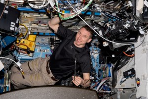 NASA astronaut and Expedition 69 Flight Engineer Woody Hoburg poses for a photo inside the Destiny module as he installs electronics and communications hardware.
