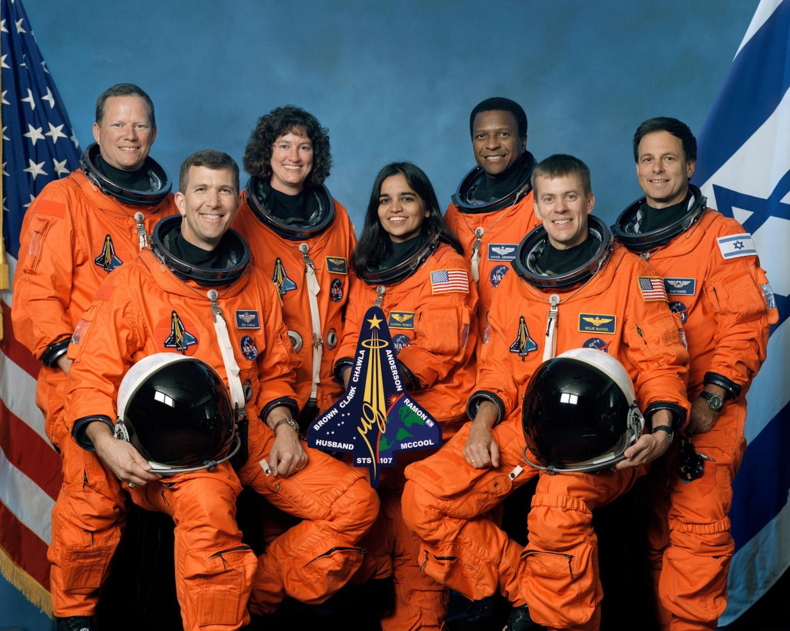 STS-107 Crew Seated in front, from left, are: Astronauts Rick D. Husband, mission commander; Kalpana Chawla, mission specialist; and William C. McCool, pilot. Standing, from left, are: David M. Brown, Laurel B. Clark, and Michael P. Anderson, all mission specialists; and Ilan Ramon, payload specialist.