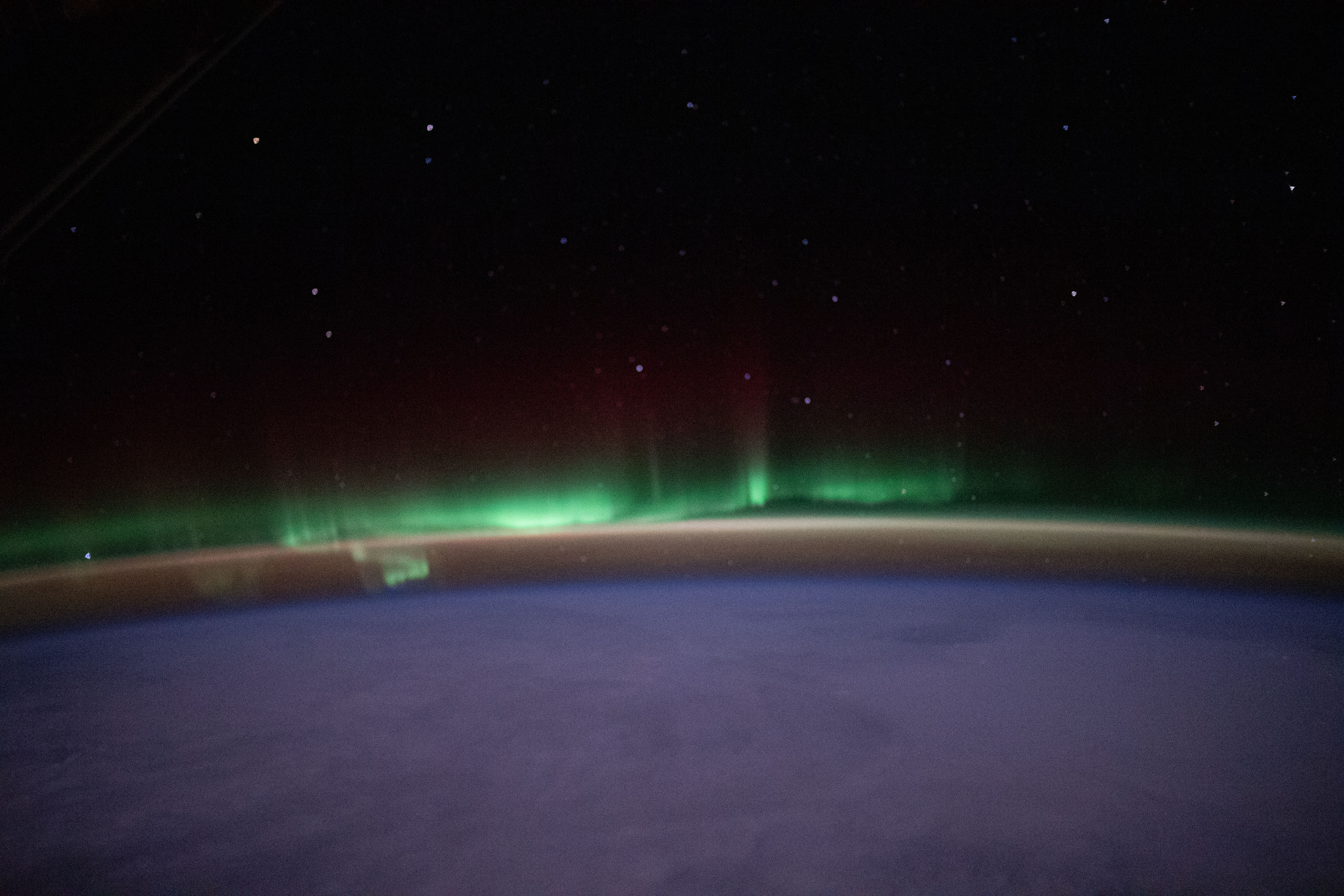 iss070e051526 (Jan. 1, 2024) -- An aurora shimmers in the night sky above Earth as the International Space Station soared 262 miles over Quebec.