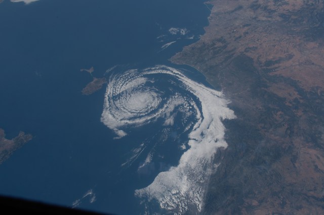 A cloud formation spirals in the Balearic Sea between Valencia, Spain, and the island of Ibiza as the International Space Station orbited above southern Europe.
