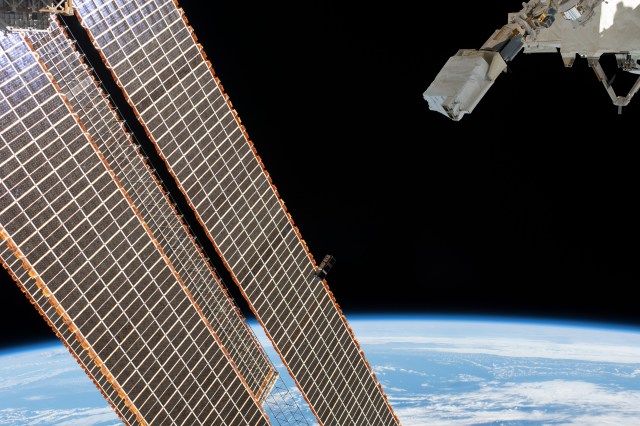 A tiny satellite from Singapore, also known as a CubeSat, is ejected from the Japanese Small Satellite Orbital Deployer past the International Space Station's solar arrays. The CubeSat was among three others from Asian nations deployed earlier for technology demonstrations in Earth orbit. The orbital complex was 254 miles above the Atlantic Ocean northeast of Venezuela when an Expedition 59 crewmember took this photograph.