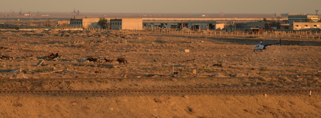 A security helicopter moves a heard of horses away from the train tracks in advance of the Soyuz rocket being rolled out to the launch pad, Tuesday, Oct. 9, 2018 at the Baikonur Cosmodrome in Kazakhstan. Expedition 57 crewmembers Nick Hague of NASA and Alexey Ovchinin of Roscosmos are scheduled to launch on October 11 and will spend the next six months living and working aboard the International Space Station.