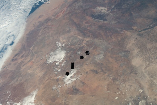 iss068e025834 (Dec. 2, 2022) --- A set of four CubeSats are photographed after being released from a small satellite deployer on the outside of the Kibo laboratory module as the International Space Station orbited 264 miles above Namibia on the African continent. The four tiny satellites, two from Japan, and one each from Uganda and Zimbabwe, were deployed into Earth orbit for a variety scientific studies and technology demonstrations.