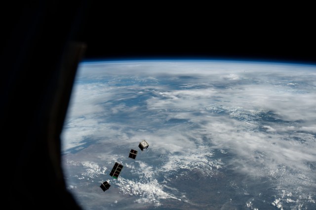 iss068e025819 (Dec. 2, 2022) --- A set of four CubeSats are photographed after being released from a small satellite deployer on the outside of the Kibo laboratory module as the International Space Station orbited 264 miles above Namibia on the African continent. The four tiny satellites, two from Japan, and one each from Uganda and Zimbabwe, were deployed into Earth orbit for a variety scientific studies and technology demonstrations.