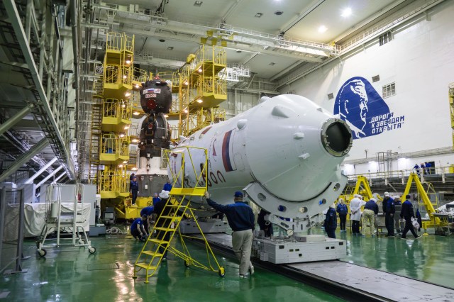 In the Integration Building at the Baikonur Cosmodrome in Kazakhstan, a technician watches over the upper stage of the Soyuz booster (foreground) and the Soyuz MS-12 spacecraft (background) March 6 prior to the spacecraft’s encapsulation into the nose fairing of the booster rocket. Expedition 59 crew members Nick Hague and Christina Koch of NASA and Alexey Ovchinin of Roscosmos will launch on March 14, U.S. time, on the Soyuz MS-12 spacecraft from the Baikonur Cosmodrome for a six-and-a-half month mission on the International Space Station.