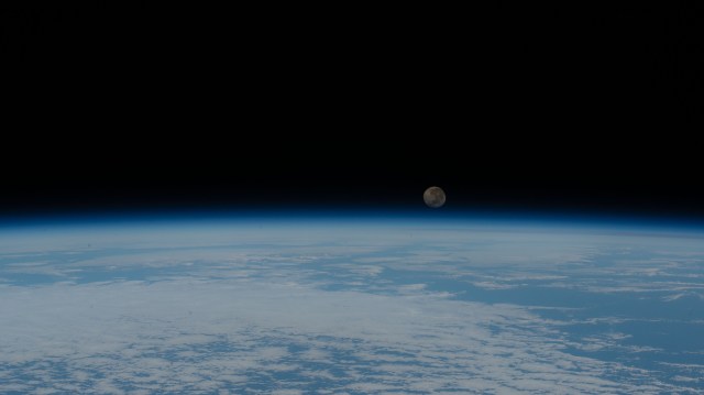 A waning gibbous Moon is pictured just above the Earth's horizon as the International Space Station orbited over the Atlantic Ocean just off the coast of the African nation of Angola.