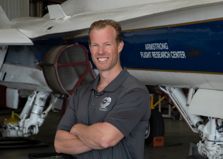 Portrait of a man standing next to an aircraft.