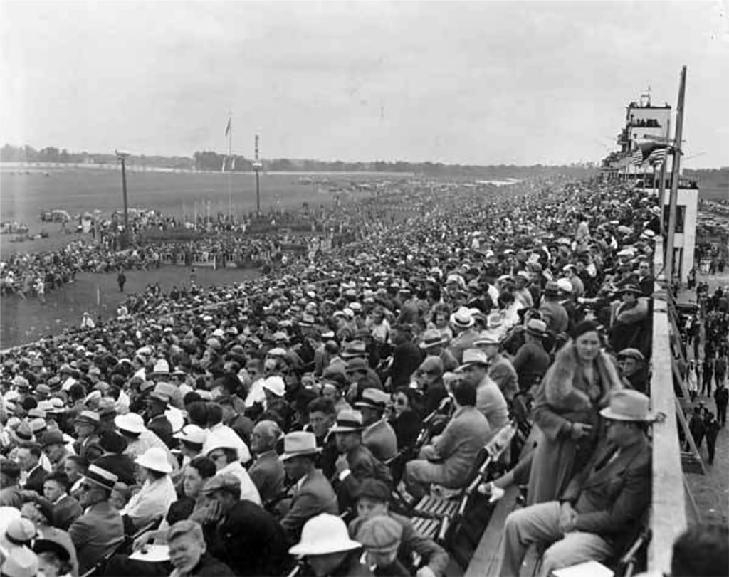 Crowd seated in grandstand.
