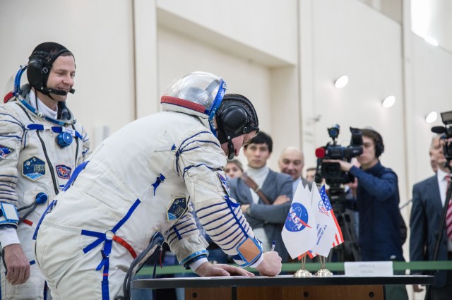 At the Gagarin Cosmonaut Training Center in Star City, Russia, Expedition 59 crew member Alexey Ovchinin of Roscosmos signs in for the second day of final pre-launch qualification exams Feb. 20 as his crewmate, Nick Hague of NASA looks on. Ovchinin, Hague and Christina Koch of NASA will launch March 14, U.S. time, in the Soyuz MS-12 spacecraft from the Baikonur Cosmodrome in Kazakhstan for a six-and-a-half month mission on the International Space Station. Credit: NASA/Beth Weissinger