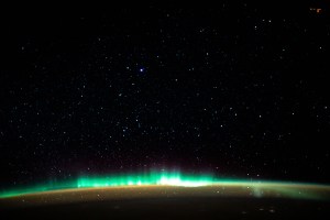 An aurora blankets the Earth beneath a celestial night sky as the International Space Station orbited 261 miles above the Atlantic Ocean off the coast of North America.