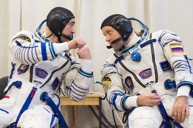 At the Baikonur Cosmodrome in Kazakhstan, Expedition 63 crewmembers Anatoly Ivanishin (left) and Ivan Vagner (right) of Roscosmos share some thoughts on procedures March 25 during pre-launch training activities. Along with Chris Cassidy of NASA, they will launch April 9 on the Soyuz MS-16 spacecraft from Baikonur for a six-and-a-half month mission on the International Space Station. Credit: Andrey Shelepin/Gagarin Cosmonaut Training Center.