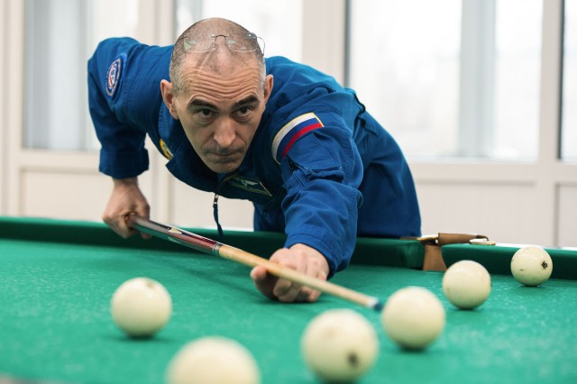 At the Cosmonaut Hotel crew quarters in Baikonur, Kazakhstan, Expedition 63 crewmember Anatoly Ivanishin of Roscosmos plays a game of billiards April 1. Ivanishin, Chris Cassidy of NASA and Ivan Vagner of Roscosmos will launch April 9 on the Soyuz MS-16 spacecraft from the Baikonur Cosmodrome in Kazakhstan for a six-and-a-half month mission on the International Space Station. Credit: Andrey Shelepin/Gagarin Cosmonaut Training Center.