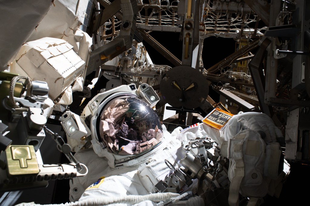 NASA astronaut and U.S. Army Colonel Andrew Morgan displays his Army pride ahead of the Army versus Navy football game scheduled for Dec. 12, 2019, during the third spacewalk to upgrade the Alpha Magnetic Spectrometer's thermal pump system.