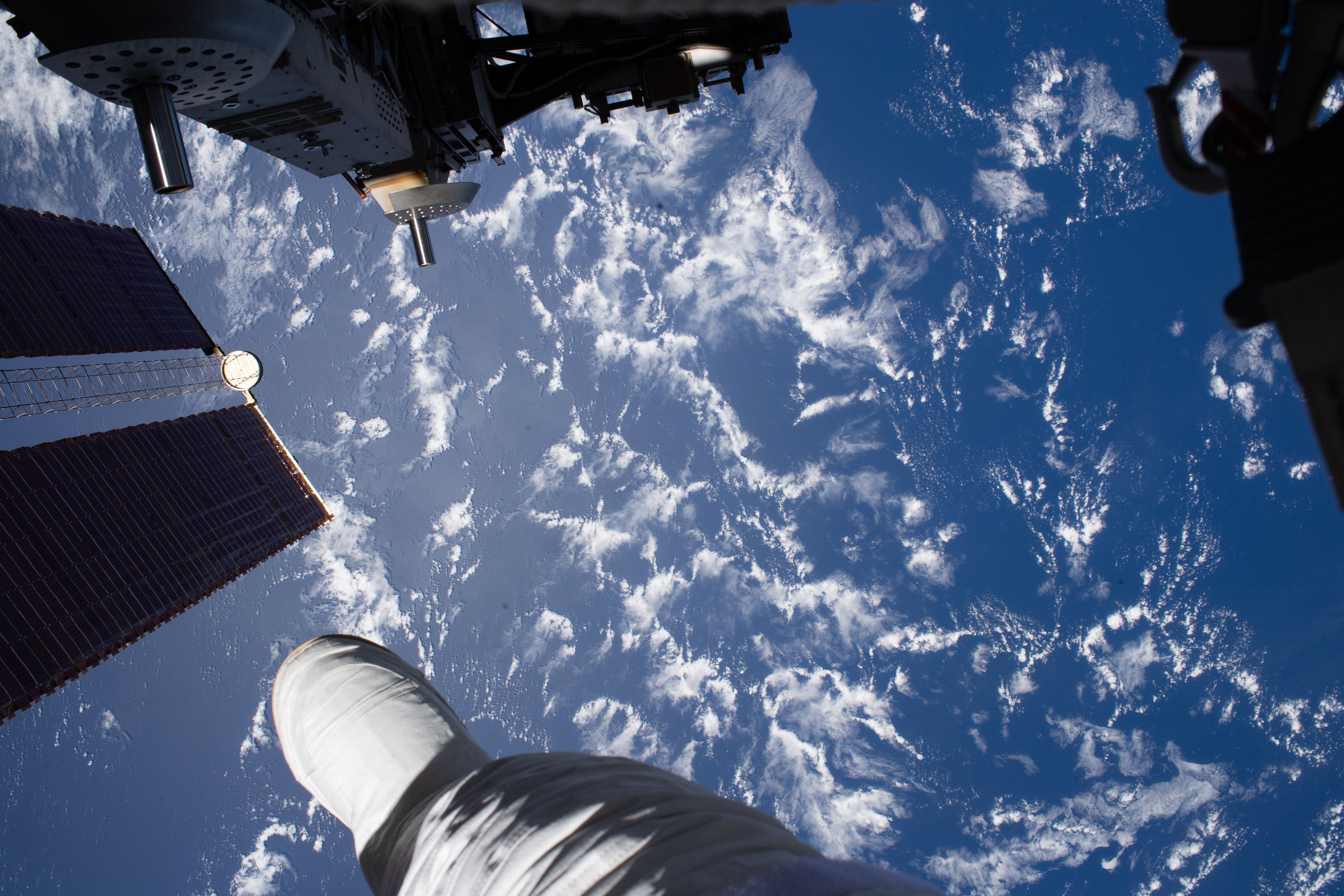 NASA astronaut Andrew Morgan photographed the Earth 250 miles below him, with his foot in the foreground, during the third spacewalk to upgrade the Alpha Magnetic Spectrometer's thermal pump system.