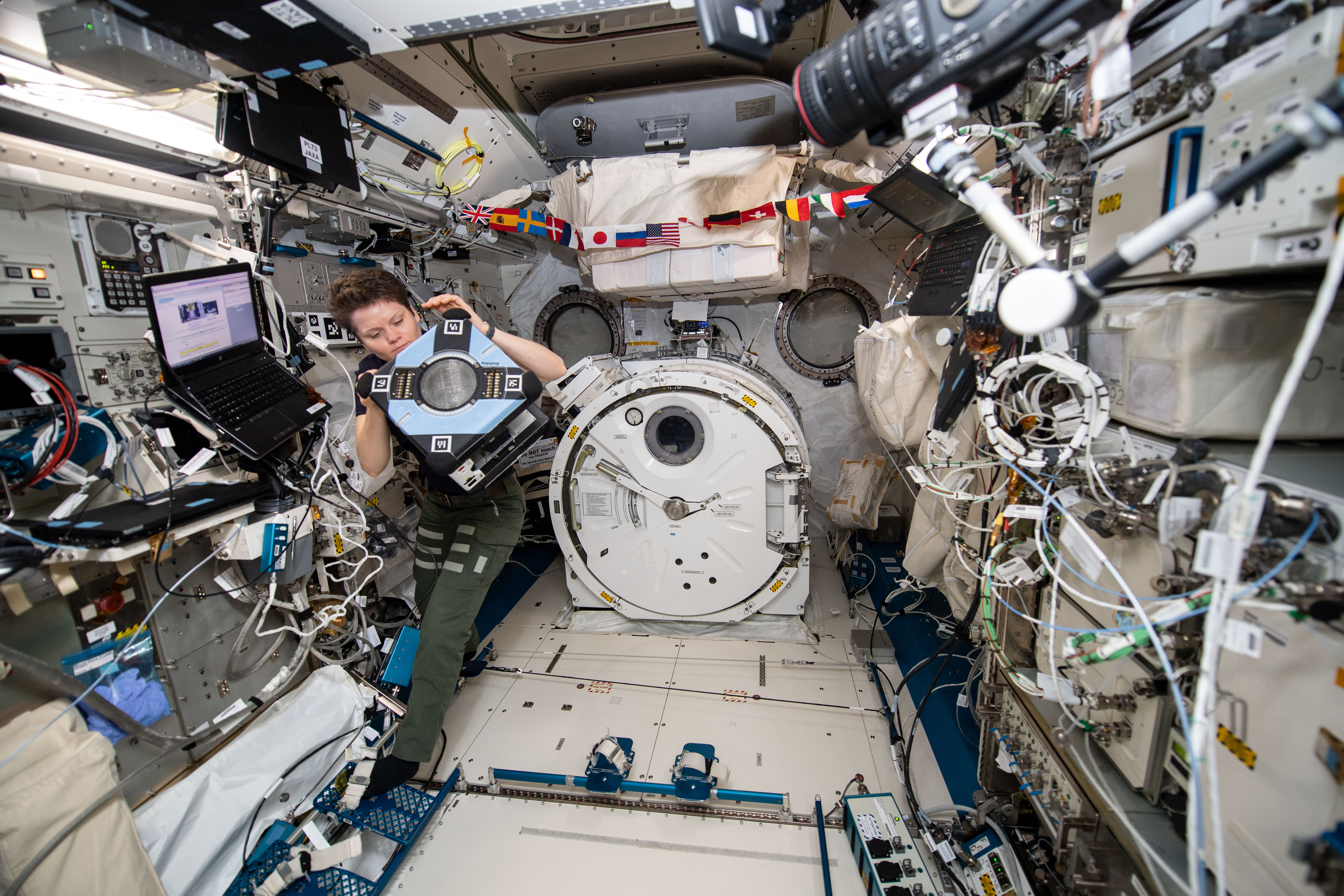 NASA astronaut Anne McClain works inside the Japanese Kibo laboratory module checking out the new Astrobee hardware. The cube-shaped, free-flying r...