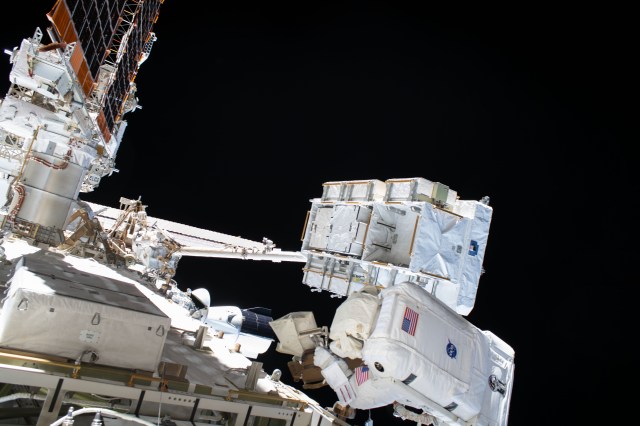 NASA astronaut and Expedition 63 Flight Engineer Bob Behnken (bottom right) works during a six-hour and one-minute spacewalk to swap an aging nickel-hydrogen battery for a new lithium-ion battery on the International Space Station's Starboard-6 truss structure. Behind Behnken is an external pallet, attached to the Canadarm2 robotic arm, where the batteries were stowed.